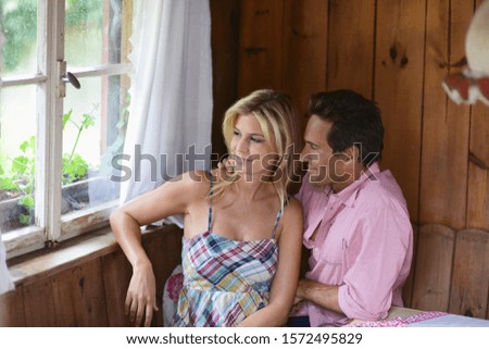 Couple sitting together and looking out of window