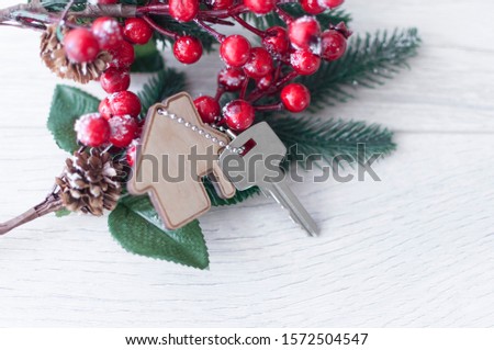Beautiful Christmas background: decorative house and key to the lock. Concept of finance and housing loans. Top view