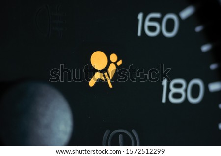 Yellow illuminated sign passenger Airbag close up Royalty-Free Stock Photo #1572512299