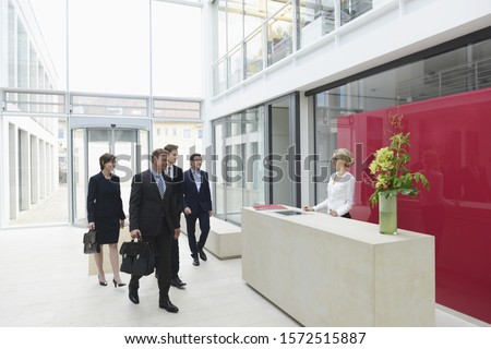 Business people arriving in offices