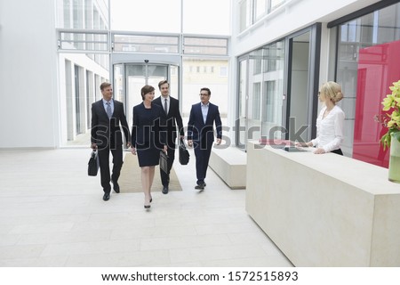 Business people arriving in offices Royalty-Free Stock Photo #1572515893