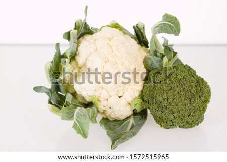 cauliflower and broccoli against white background