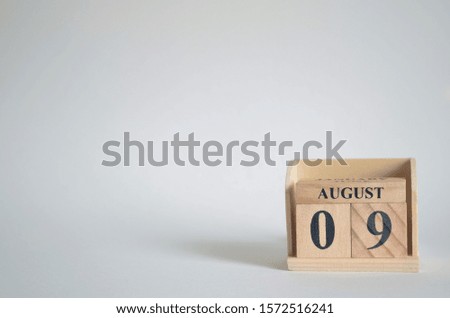 Empty white background with number cube on the table, August 9.