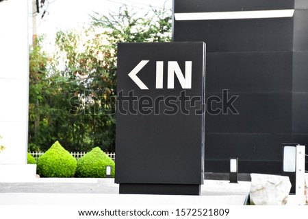 Main office entrance  Modern style with symbols (in). White letter sign on black background.