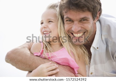 Portrait of father and daughter, smiling