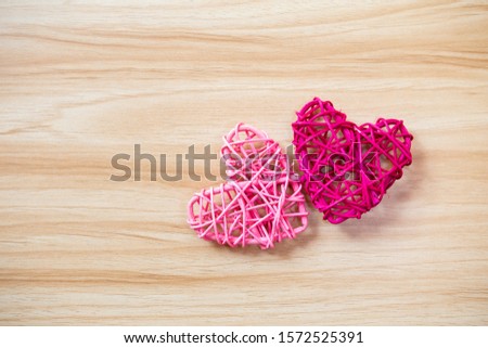 Pink heart on wooden table background, design wooden heart with space on wood background, valentine concept
