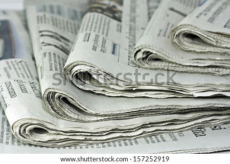 newspapers against plain background shot with very shallow depth of field Royalty-Free Stock Photo #157252919