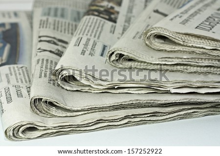 newspapers against plain background shot with very shallow depth of field Royalty-Free Stock Photo #157252922
