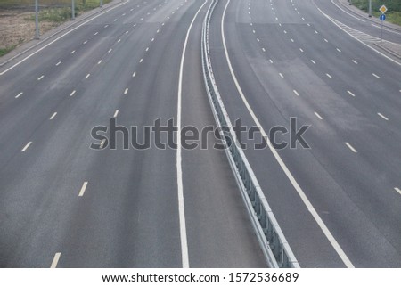 Multi-lane highway with markings on asphalt without cars