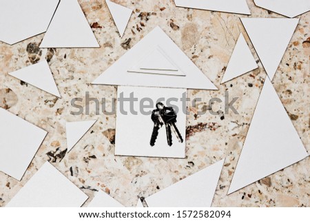 Keys on the background of houses on a marble background close-up