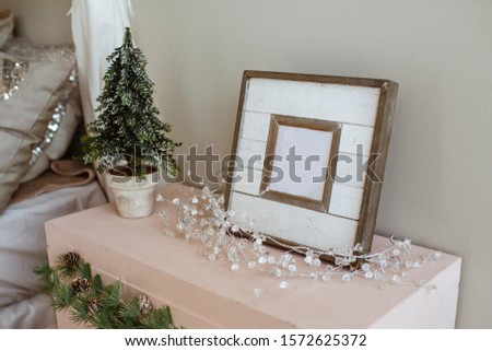 Christmas atmosphere. Bedroom decorated with fir branches and wooden frames.
