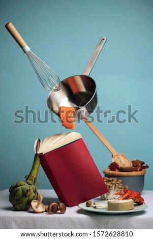 Close-up photograph of food, cooking using recipes book. Pop art picture. Seafood food levitation