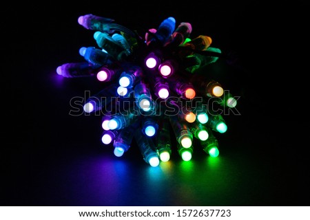 Glowing RGB led pixels christmas holiday lights on black background
