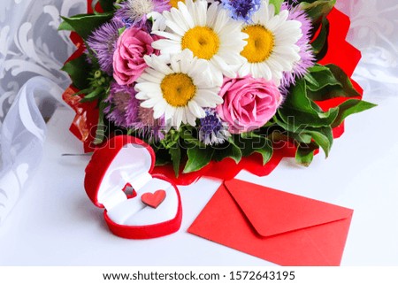 St Valentine's Day concept. bouquet of flowers, red wooden heart and gift box