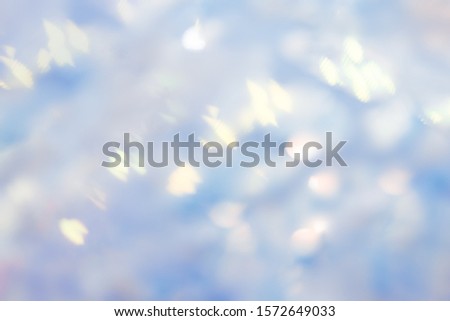 Background sequin, glitter surfactant. Holiday abstract glitter background with blinking lights. Fabric sequins in bright colors. Fashion fabric glitter, sequins, blue