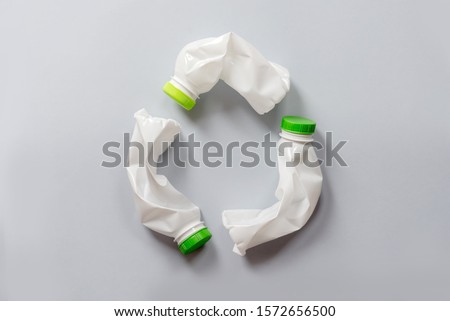 Used white plastic packaging for food on a gray background. The concept of protecting the environment from plastic waste contamination. Flat lay Royalty-Free Stock Photo #1572656500