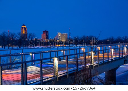 Gray's Lake Bridge with Des Moines city skyline at night