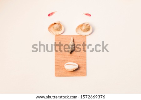 Creative face of different items, seashells, cotton pads, a piece of lamination