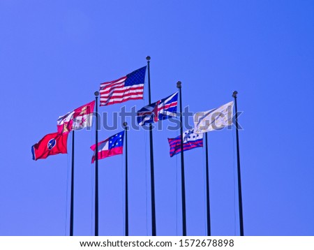 Taken on Mud Island in Memphis Tennessee, some great national flags on very tall flag poles flapping in the wind against a stunningly blue sky.
