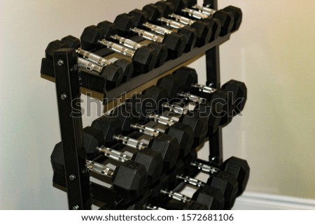 Every size of dumbbell on its rack in a fitness room. Is provided for customers, villagers or livers practice weight training exercise for their muscle strength