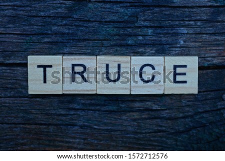 word truce made from brown wooden letters lies on a gray background