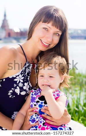 Mother and child on city backdrop