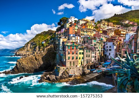 Riomaggiore fisherman village in a dramatic windy weather. Riomaggiore is one of five famous colorful villages of Cinque Terre in Italy, suspended between sea and land on sheer cliffs. Royalty-Free Stock Photo #157275353