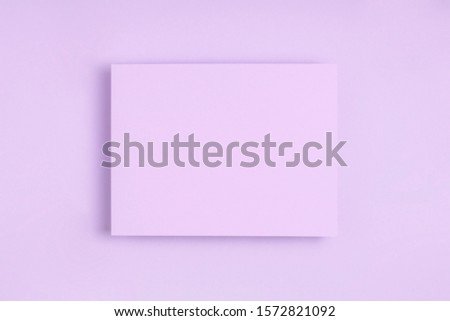 Minimal frame geometric composition mock up. Blank sheet of lilac paper on delicate blue background. Template design invitation card. Top view, flat lay, copy space. Horizontal orientation. Royalty-Free Stock Photo #1572821092