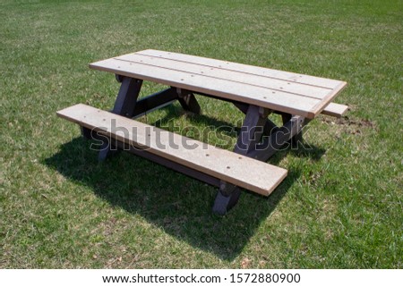 A picnic table on green lawn.