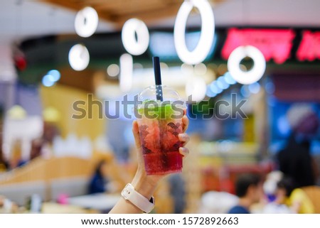 a plastic glass of refreshing iced ruby tea soda, fruit juice and flavored syrup topped with jelly  Selective focus. X'mas theme 