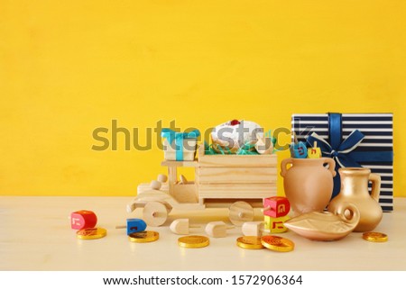 religion image of jewish holiday Hanukkah background with spinning top and doughnut