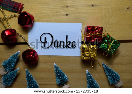Danke write on label with wooden backgroud. It means Thank You. Frame of Christmas Decoration.