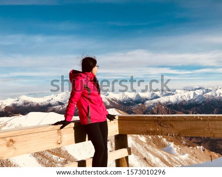 Beautiful Asian Vietnamese girl in pink ski jacket in snow field ski field cover in snow Remarkable ski field in New Zealand South Island winter time cold chilling weather 
