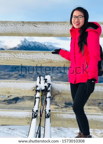 Beautiful Asian Vietnamese girl in pink ski jacket in snow field ski field cover in snow Remarkable ski field in New Zealand South Island winter time cold chilling weather 