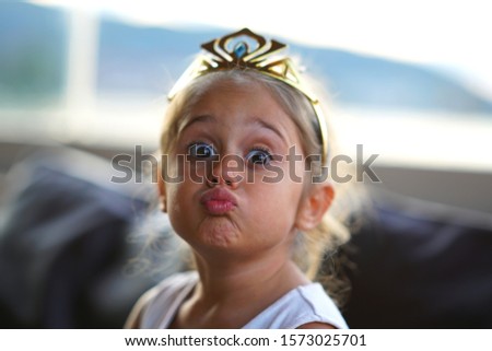 Portrait of 4 year old girl that makes the funny face