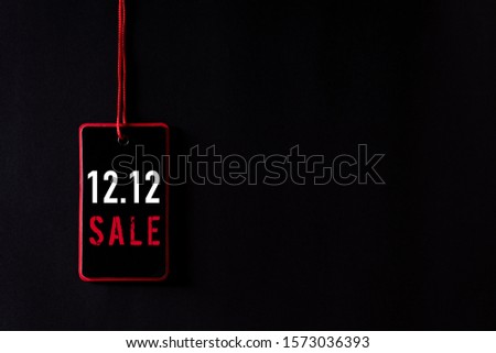Online shopping of China, 12.12 singles day sale concept. Top view of Black and red paper tag with the text 12.12 singles day sale on a black background.