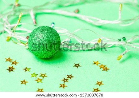 Christmas decoration on the green background. Ornaments, snowflakes, stars. Copy space.