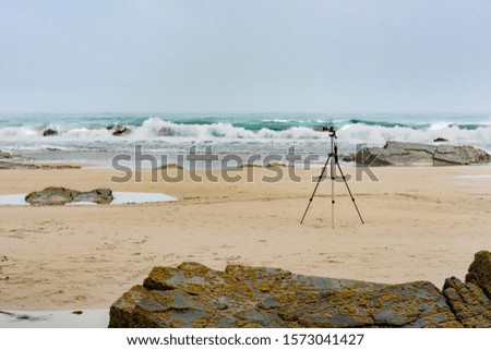 Camera and tripod on the beach
