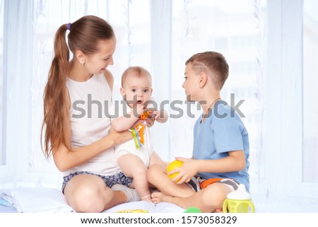 mother with two children near the window
