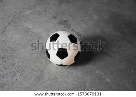 Soccer ball, football on the concrete flooring