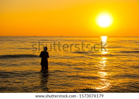 The fisherman cast a net the sea in the morning, at sunrise