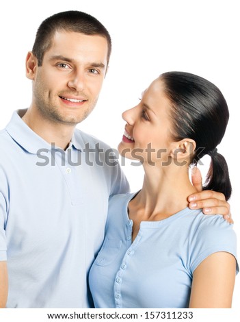 Portrait of young happy smiling attractive embracing couple, isolated on white background