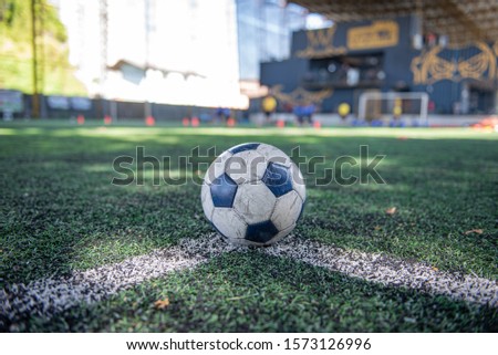 Football (Soccer) in the pitch with line field and football training equipment such as marker and cone, we can usually see this in football club academy.