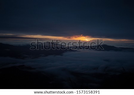 Scenic landscape in foggy valley at dawn, doi pha tung Chiengrai Thailand