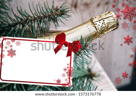 sparkling wine and Christmas tree branch in a wooden box on a wooden background, place for text, red bow, bottle of champagne, wishes for Christmas and New Year