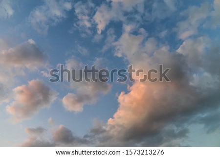 The image of the sky with clouds at sunset.
