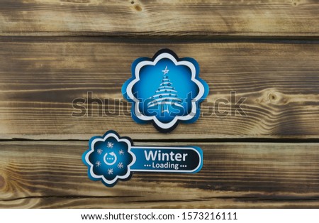 Blue sticker with Christmas illustration on wooden background