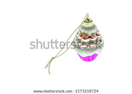Christmas decorations. Christmas toys made of glass and ceramics. On a white background. Small cake tree car candy golden star red ball ceramic little horse. Decorations, holidays. Light reflections.