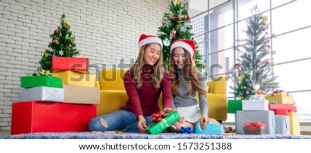 Happy Merry Christmas holidays tradition Cute young couple smile take photo each other embrace light up, celebrate seasonal couple women give gift each other. Christmas concept.