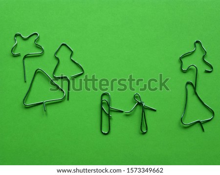 meeting in the park of lovers. installation of paper clips on a green background
